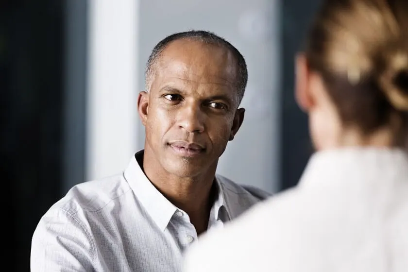 Man listening closely during a consultation with a clinician