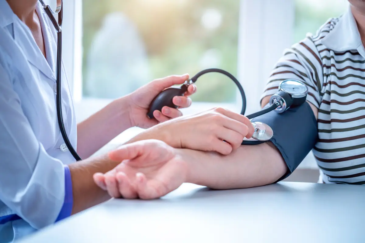 Blood pressure cuff on a patient's arm