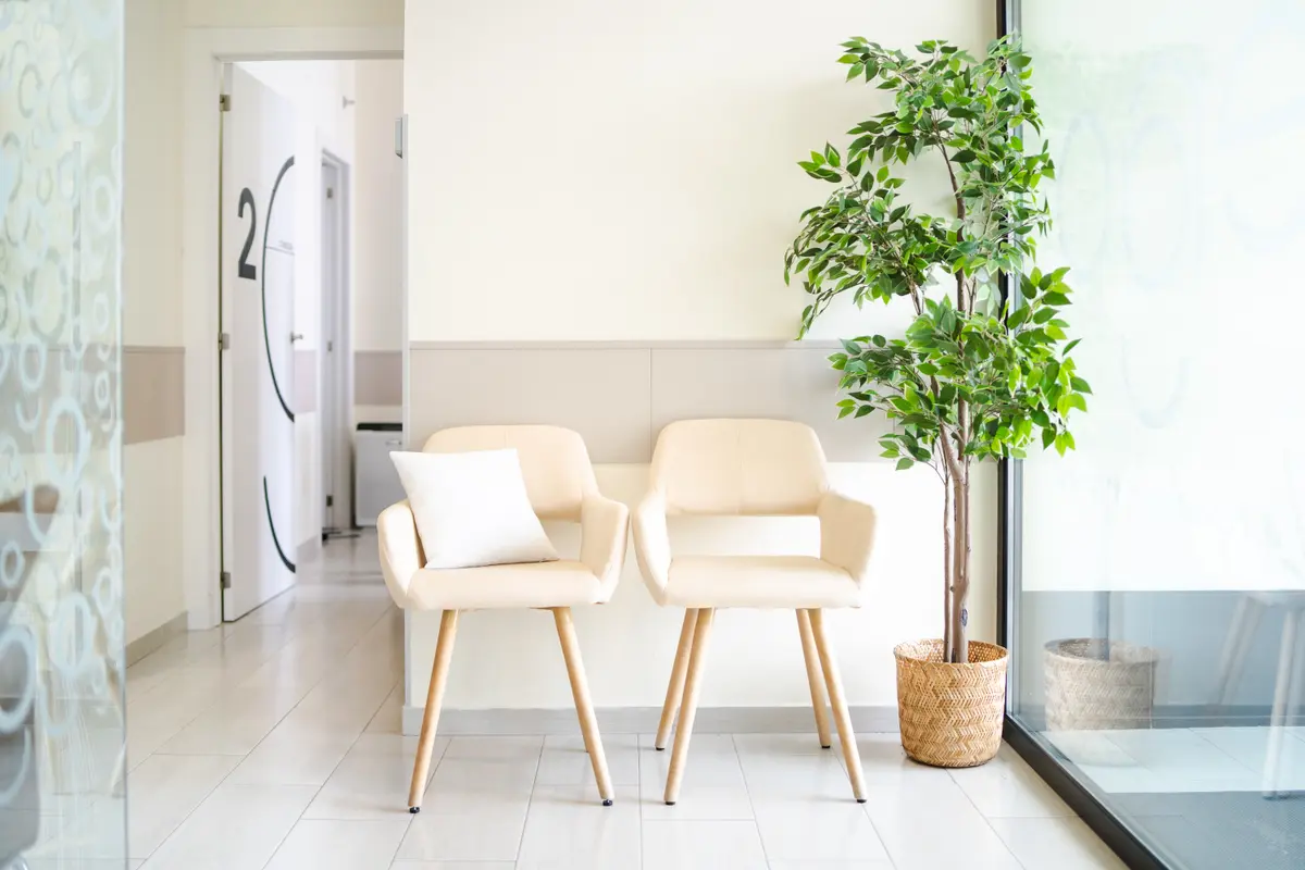 Bright clinic waiting area with two chairs