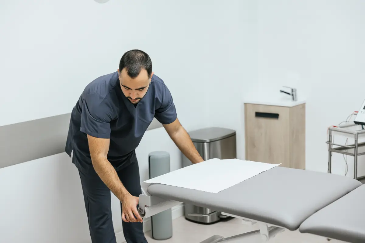 Clinician preparing an exam table