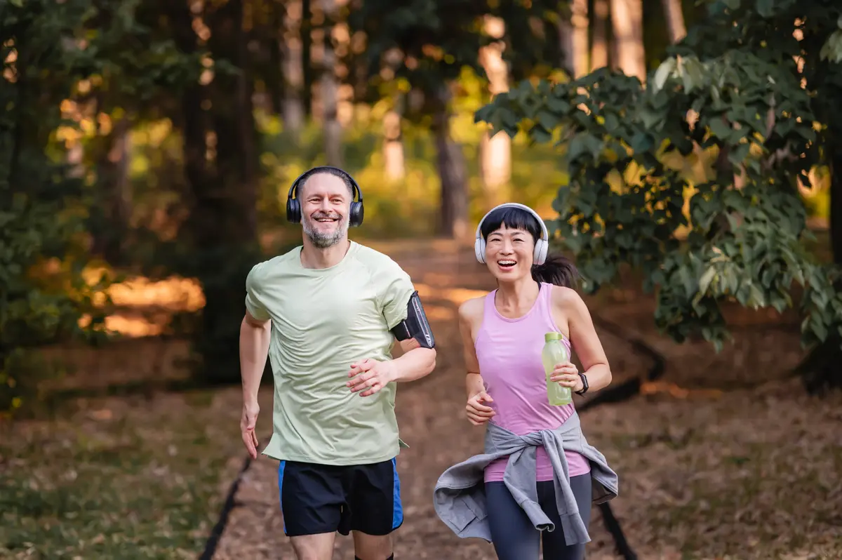 Couple jogging on a forest path