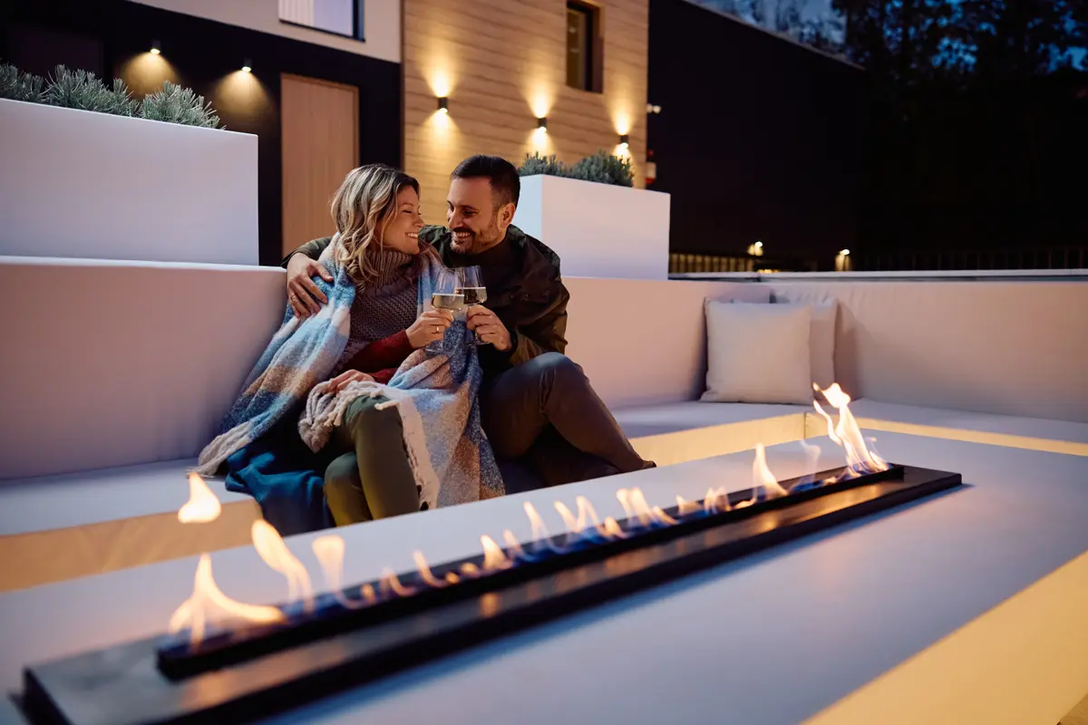 Couple sitting by a fire pit at night