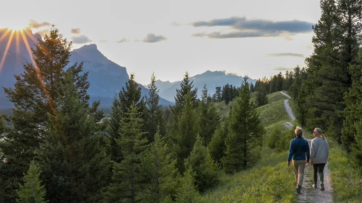 Couple walking a mountain trail