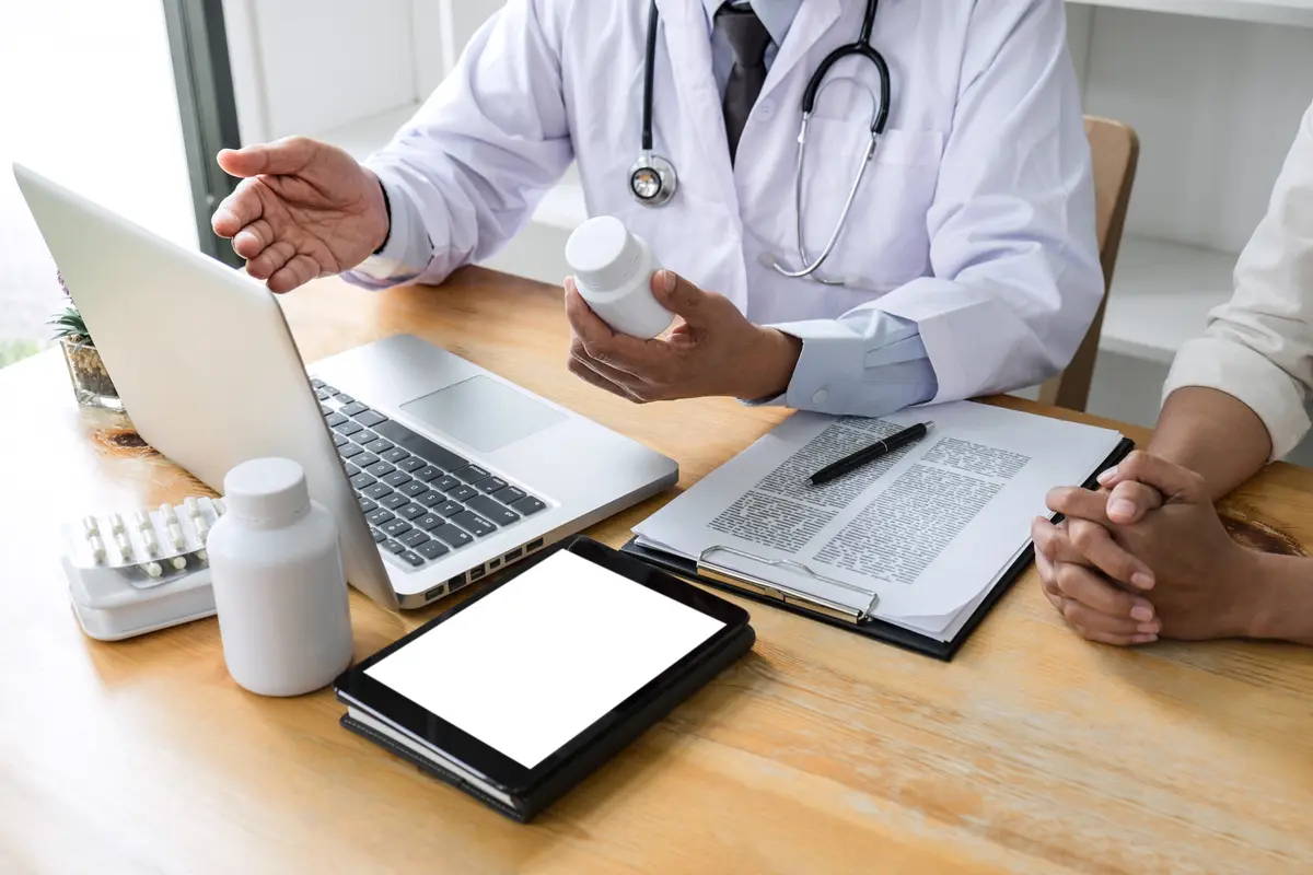 Doctor discussing a medicine bottle with a patient