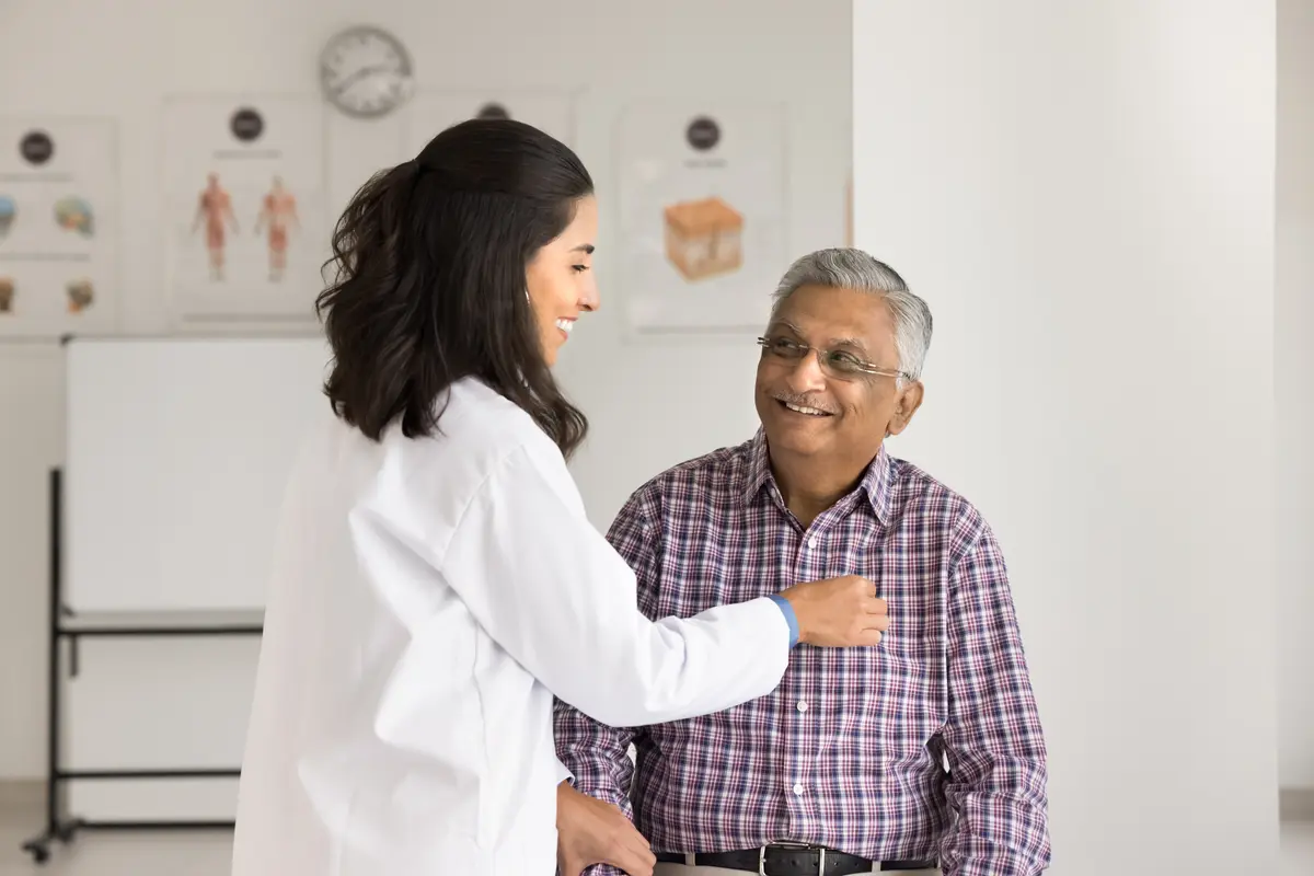 Doctor greeting an older male patient