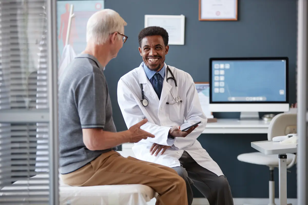 Doctor with a tablet talking to an older patient