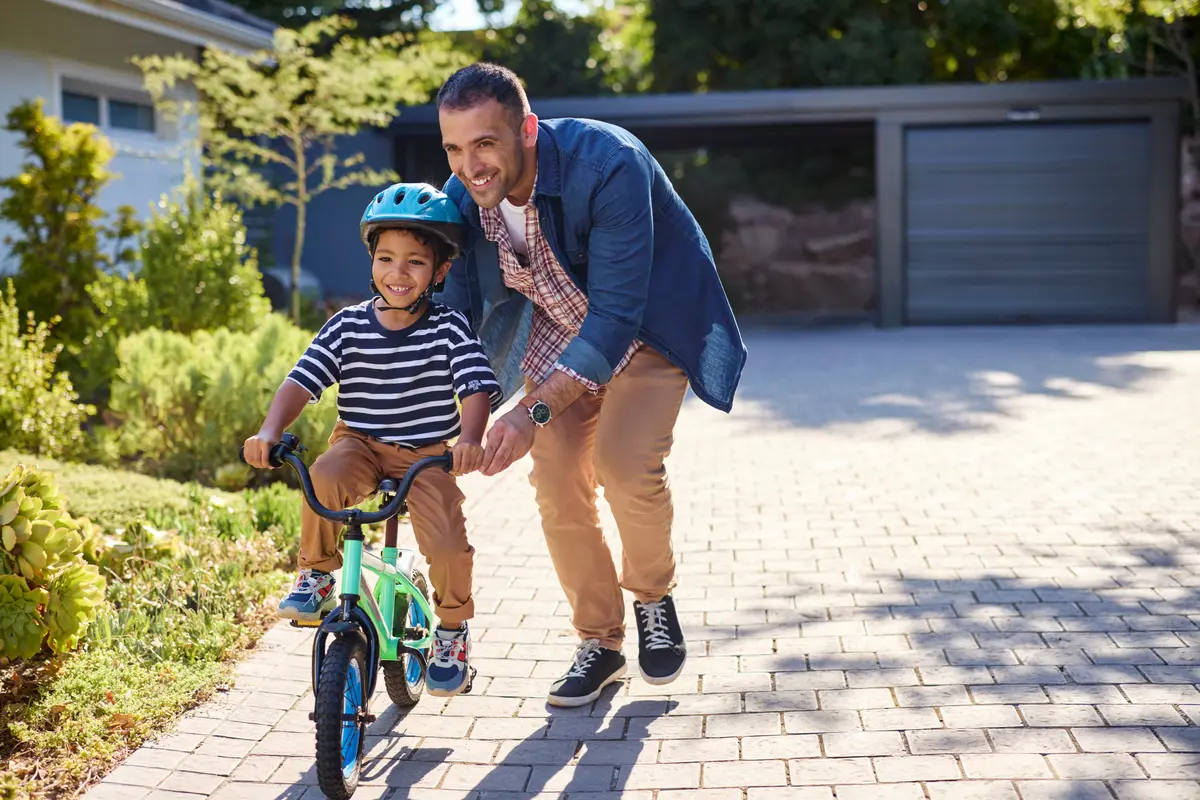 Father teaching his son to ride a bike