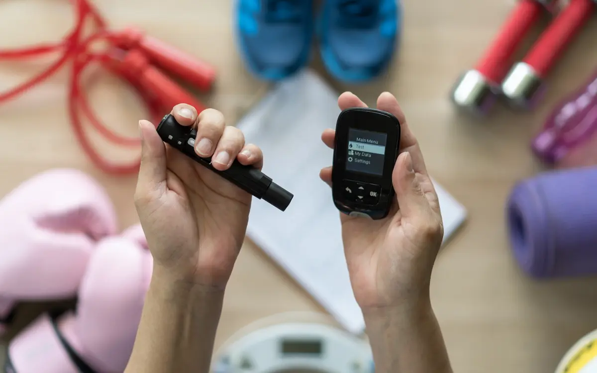 Glucose meter and lancet in hand