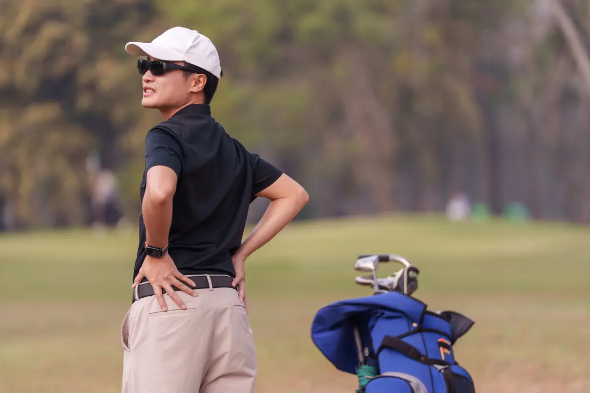 Golfer holding his lower back
