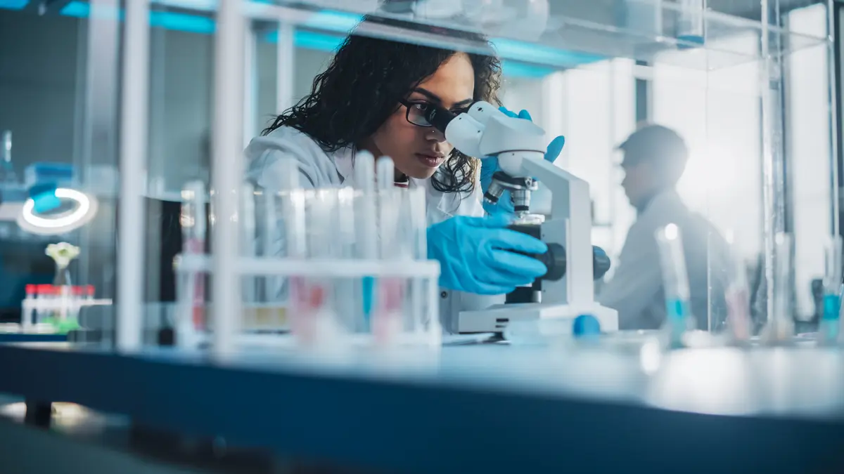 Lab scientist using a microscope