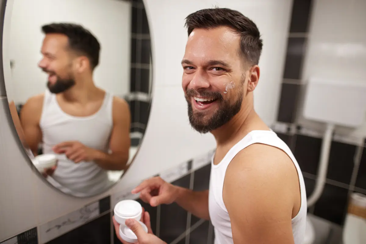 Man applying face cream in the morning