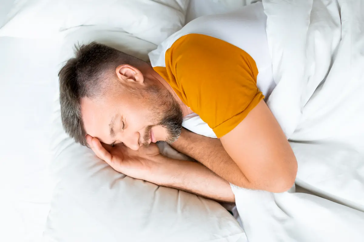 Man asleep in bed