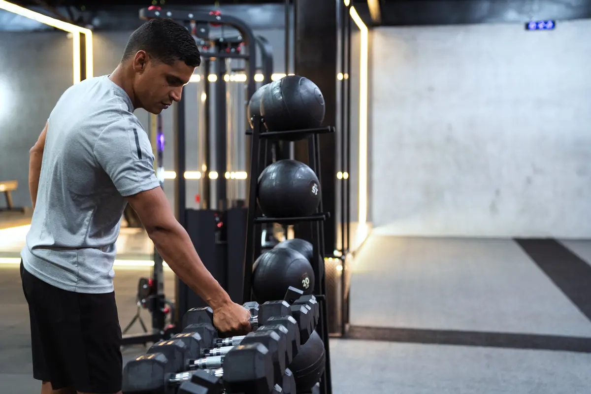 Man choosing a medicine ball from a gym rack