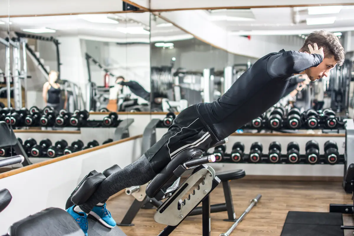 Man doing a back extension in a gym