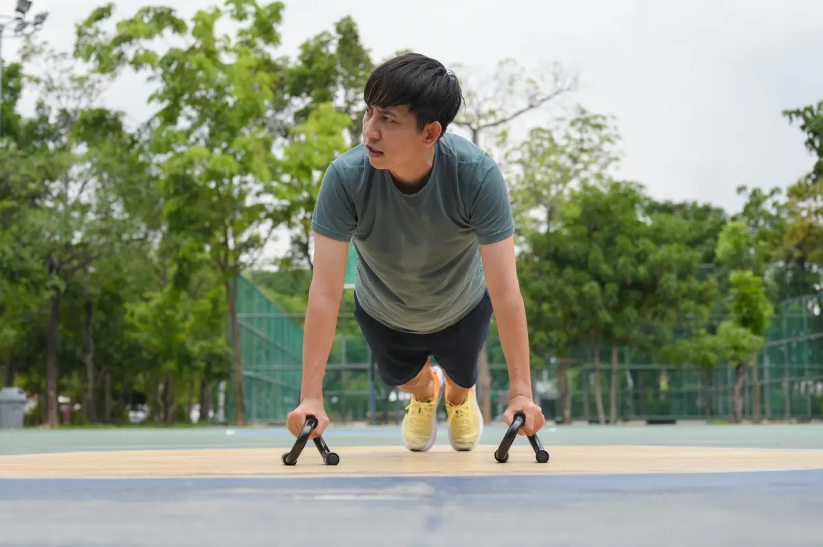 Man doing push-ups in a park