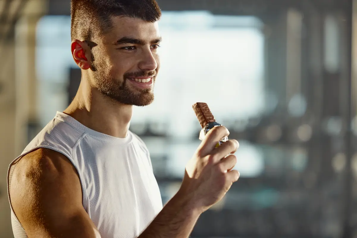 Man eating a protein bar after a workout