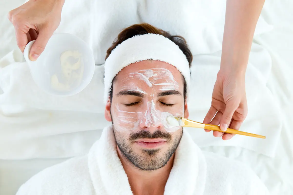 Man getting a facial mask applied