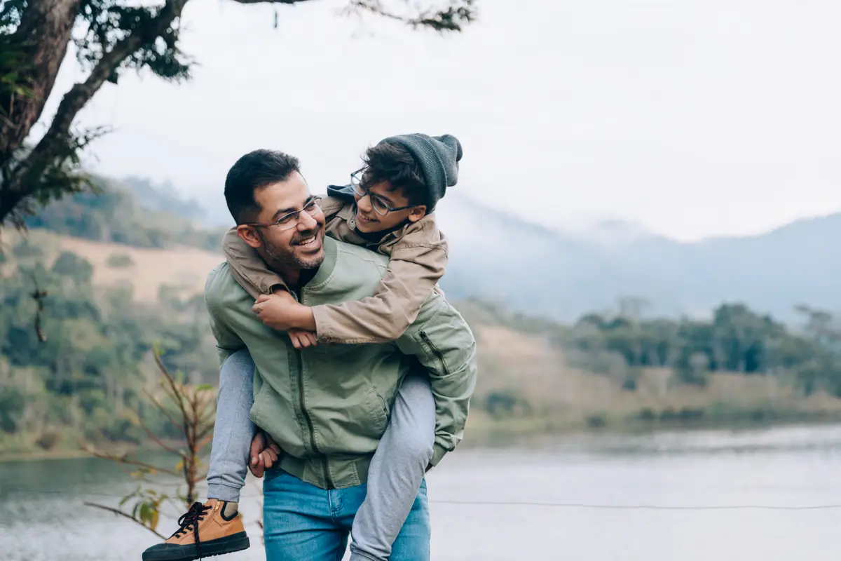Man giving his partner a piggyback ride outdoors