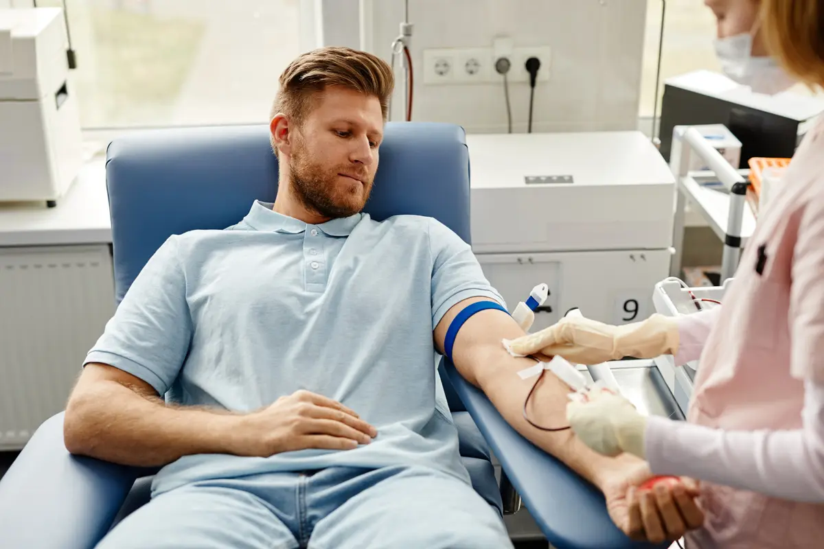 Man in a clinic chair having blood drawn