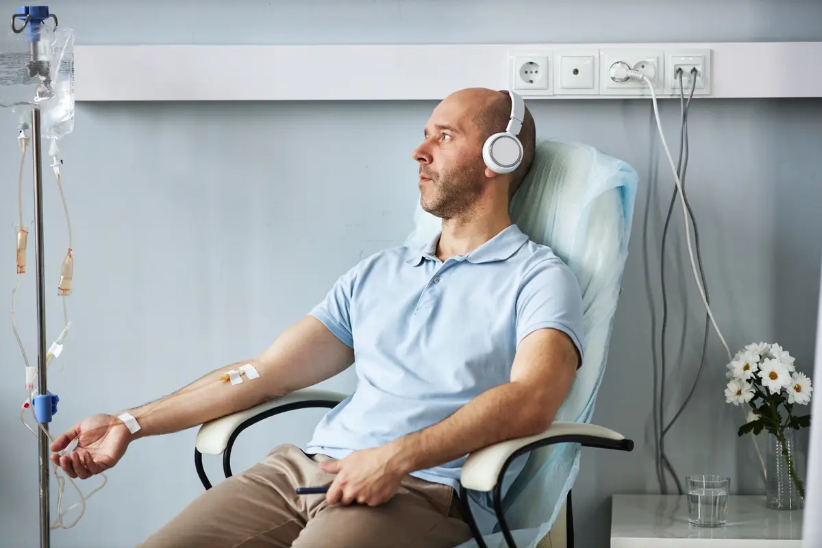 Man listening to music during an IV drip