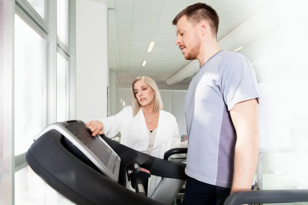 Man on a treadmill test with a clinician