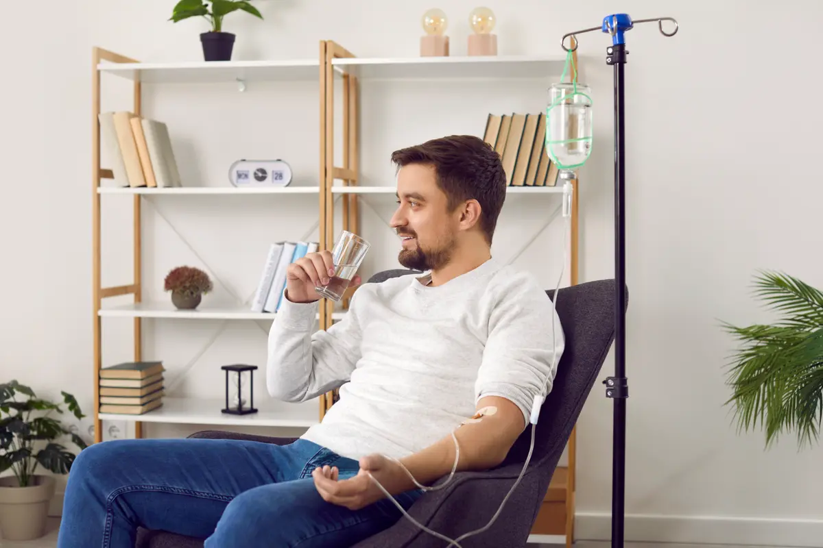 Man relaxing in a chair during an IV infusion
