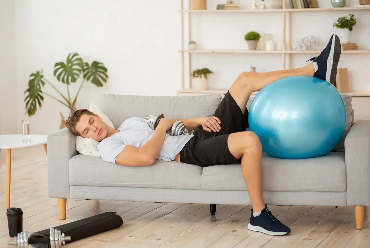Man resting on a couch after a workout