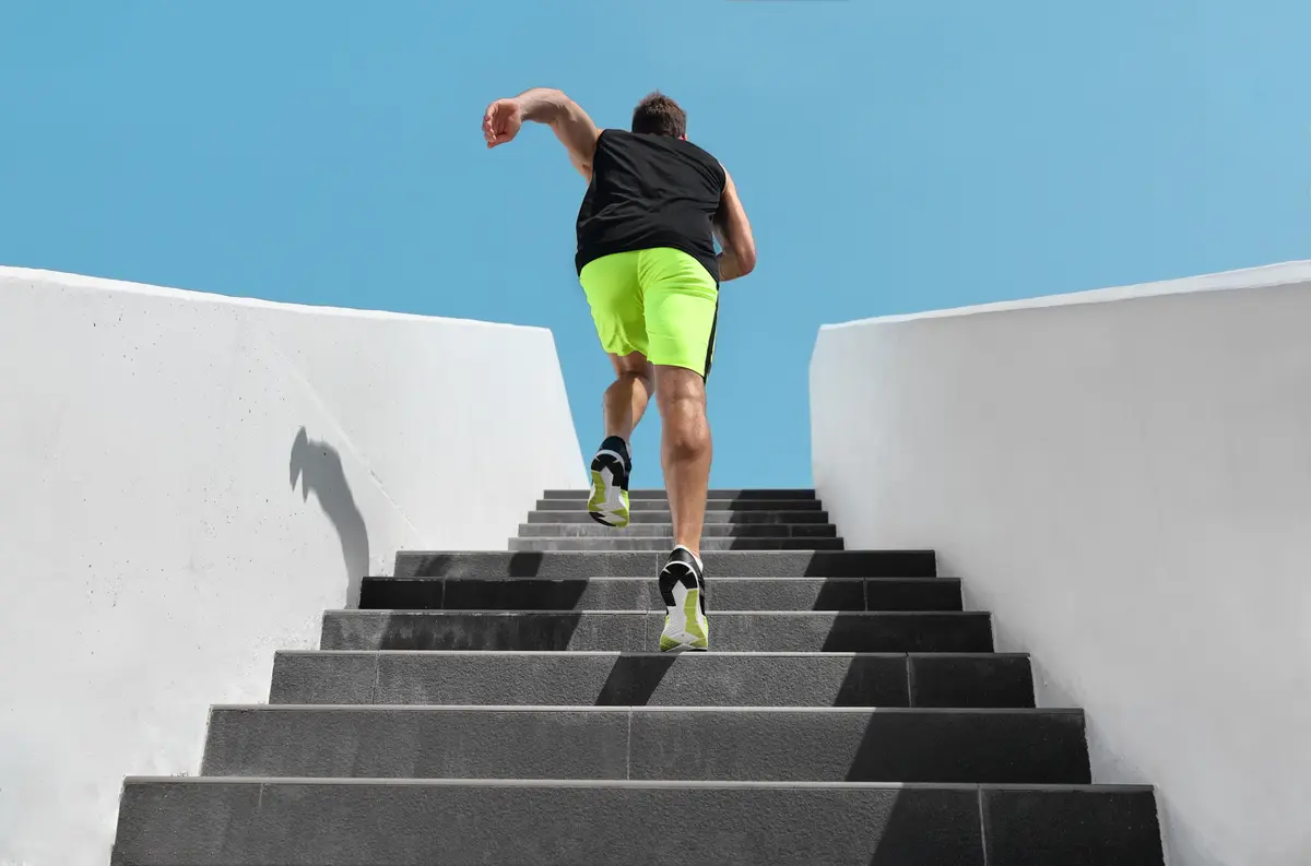 Man running up a flight of white steps
