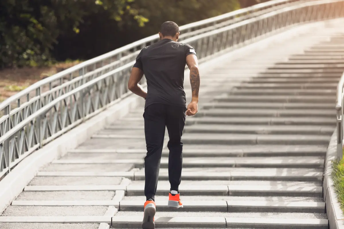 Man running up outdoor stairs