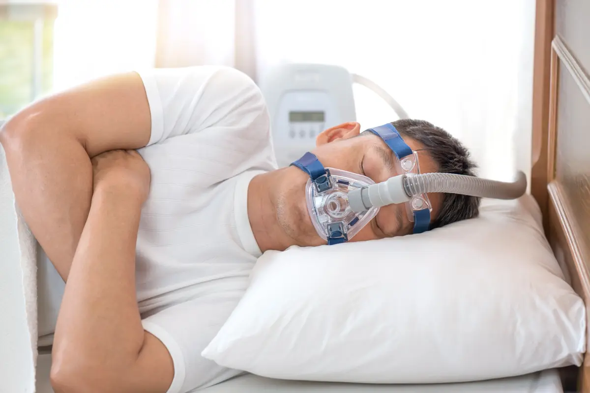 Man sleeping with a CPAP mask