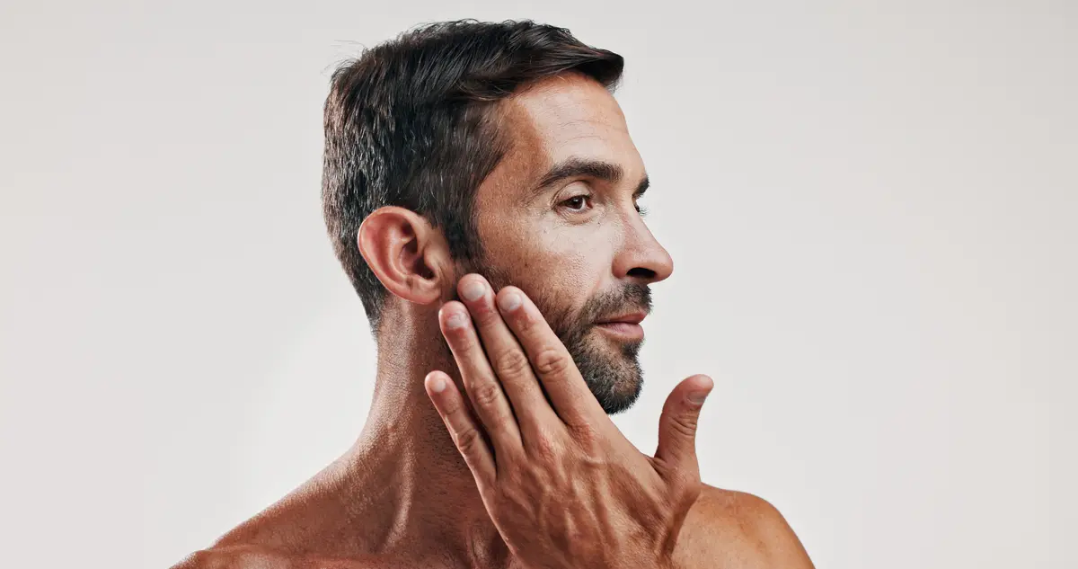 Man touching his jaw and beard