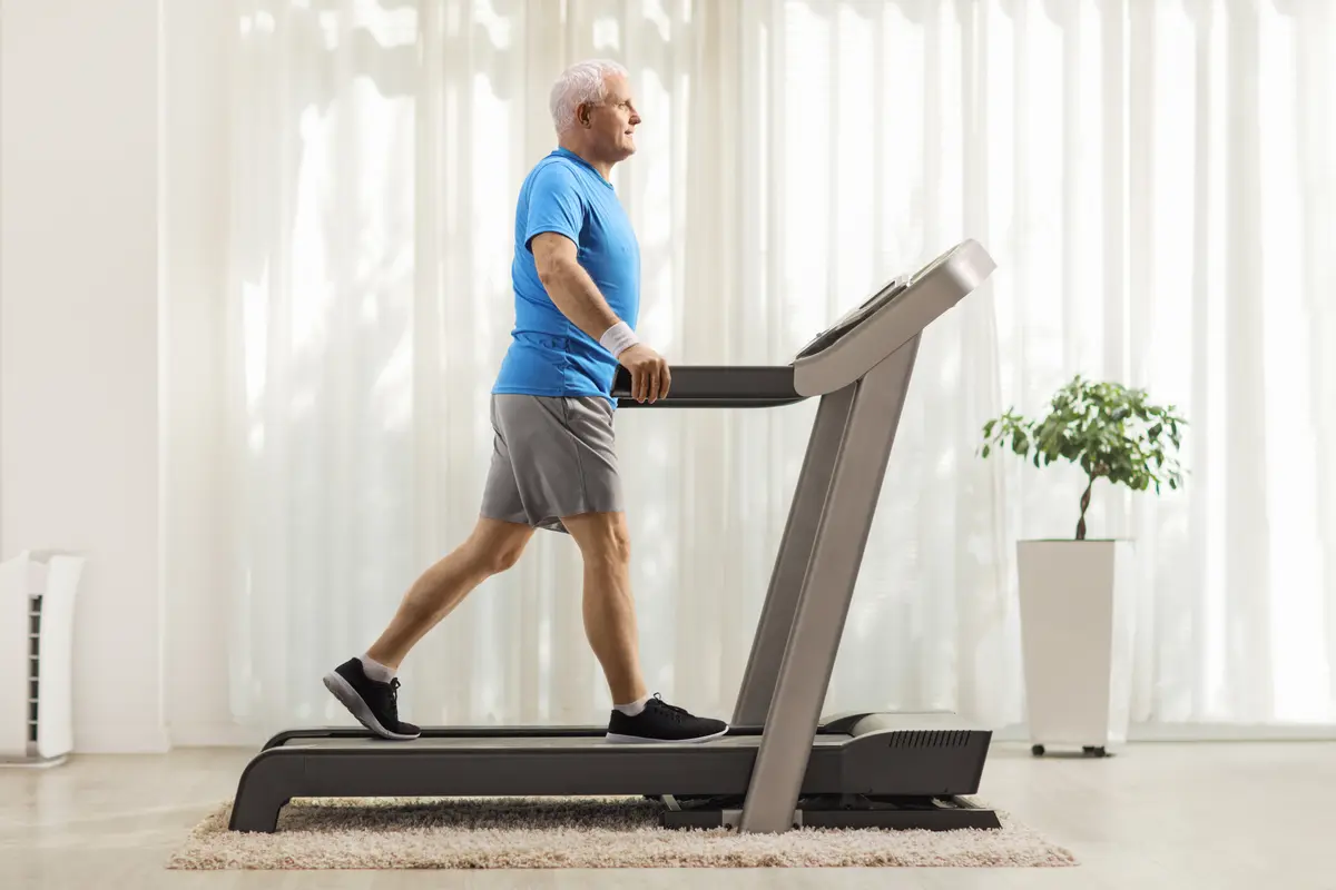 Man walking on a treadmill at home