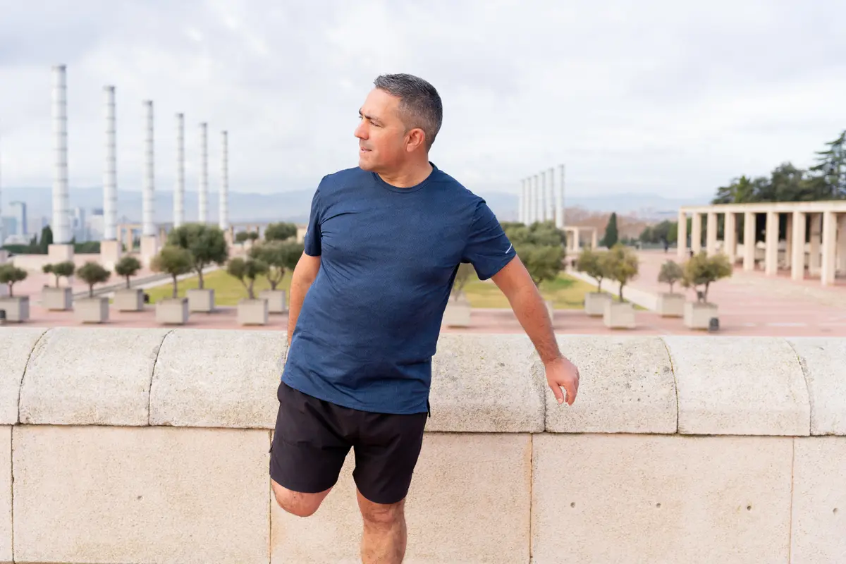 Mature man stretching before a run in the city