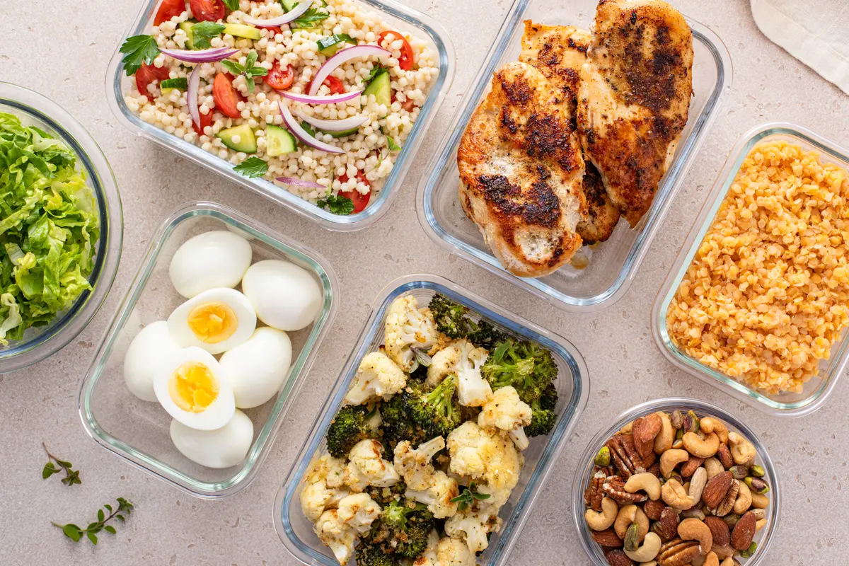 Meal prep containers with chicken, eggs and vegetables