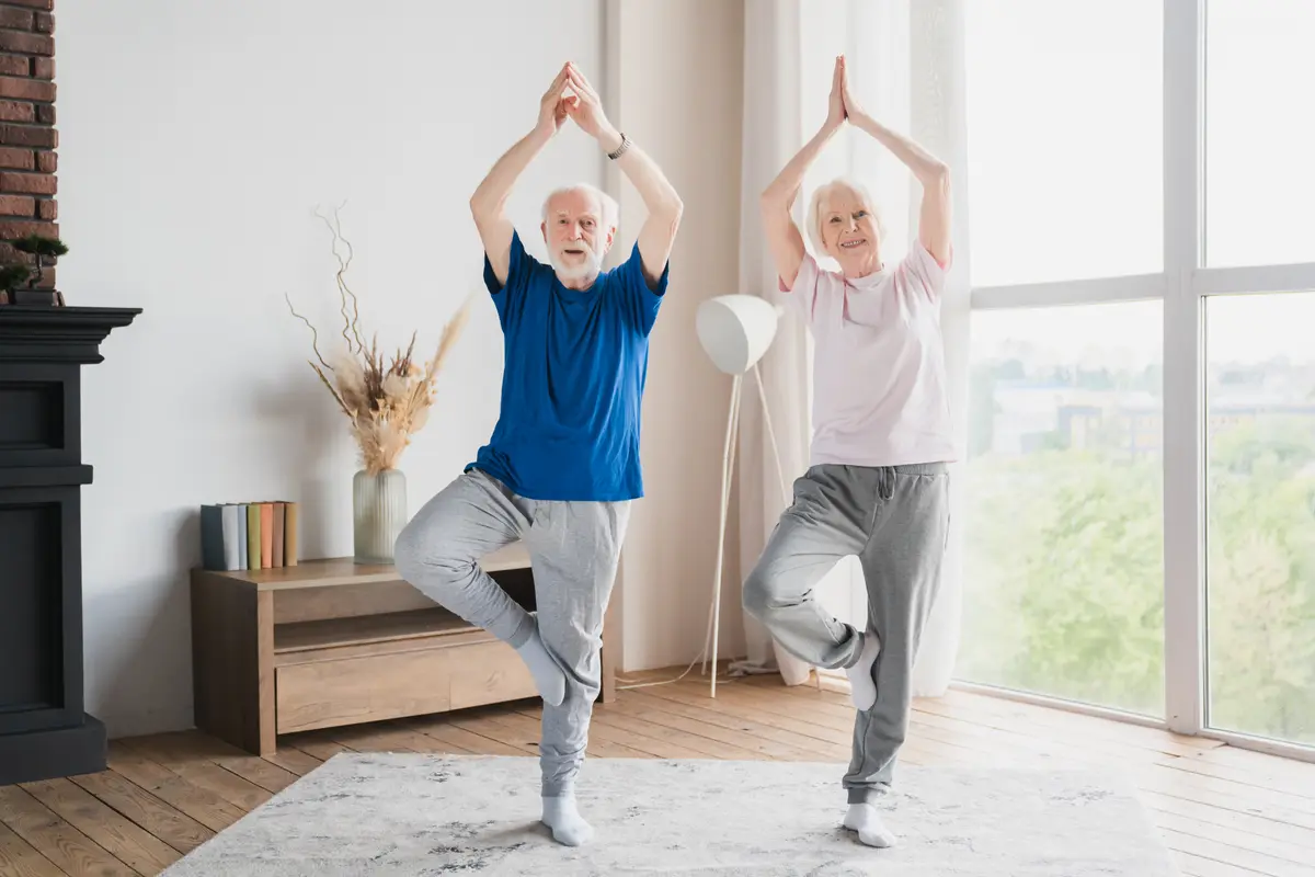Older couple doing yoga at home