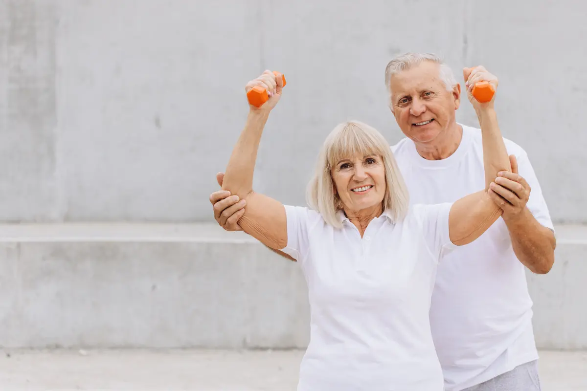 Older couple exercising with dumbbells
