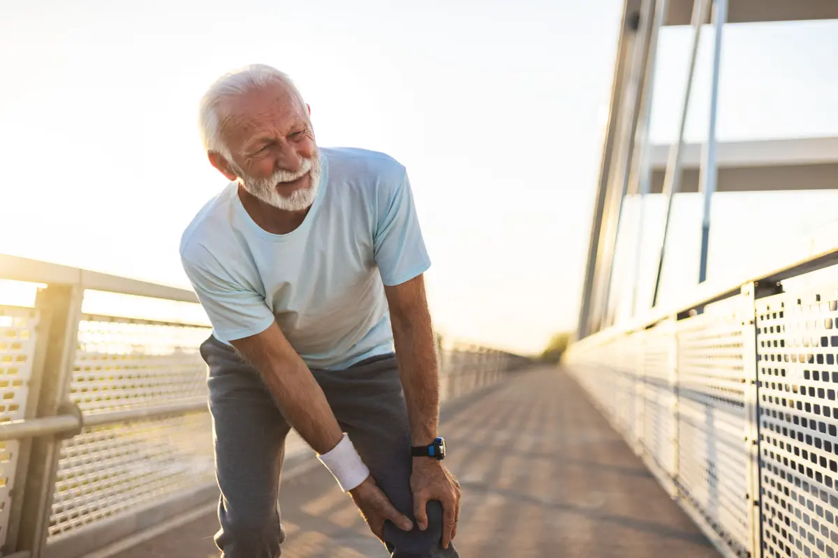 Older man catching his breath after a run