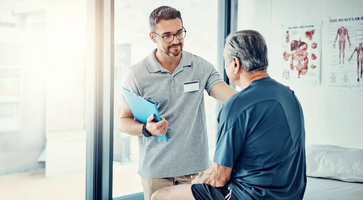 Provider talking with an older patient in a clinic