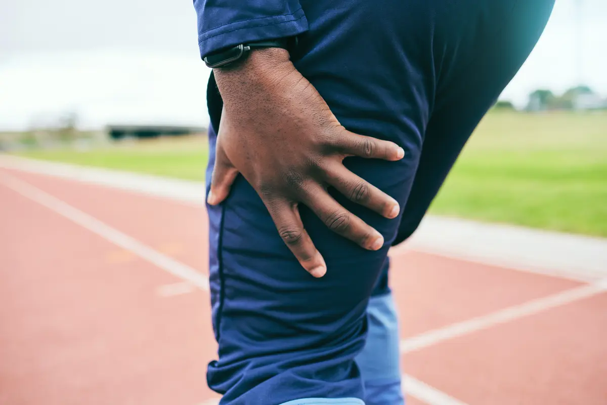 Runner holding the back of his thigh