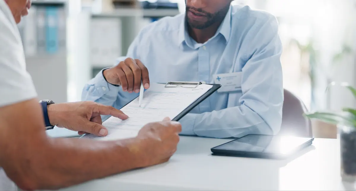 Signing a consent form on a clipboard