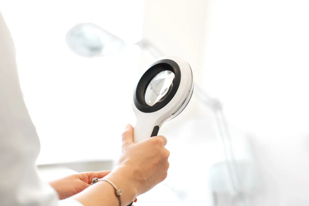 Skin check with a magnifying glass