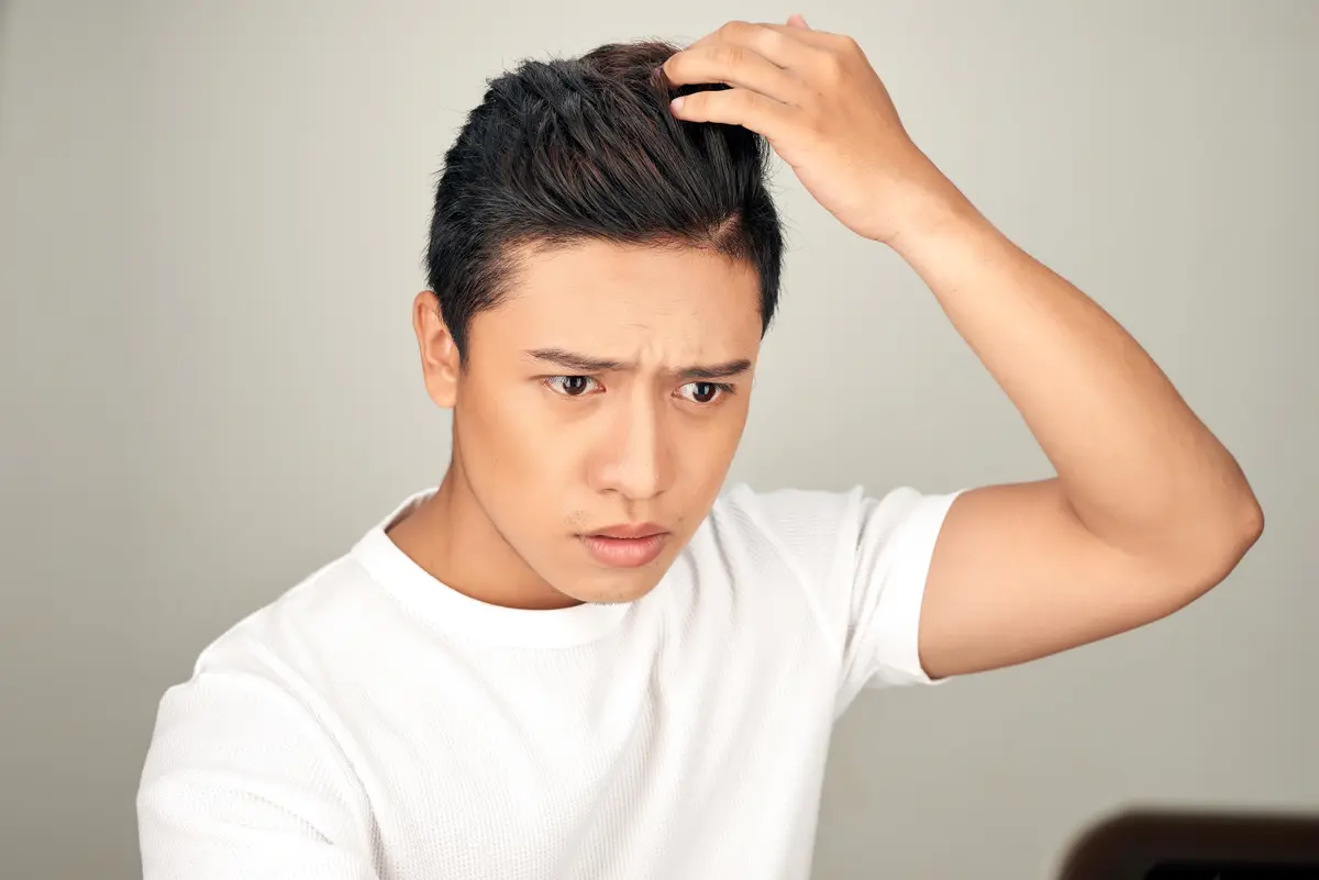 Young man checking his hair